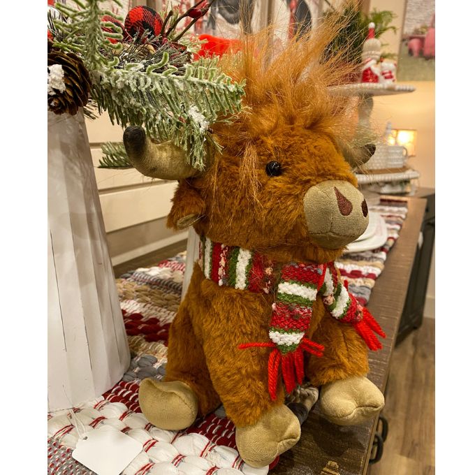 Highland Cow Stuffie with a red and green scarf is available at Quilted Cabin Home Decor.