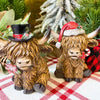 Christmas Highland Cow Figurines - Two Styles are ready for Christmas with their hats - one with a top hat and the other a red Santa Hat. Available at Quilted Cabin Home Decor.