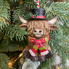 Decorative Highland cow ornament with a top hat and scarf on a Christmas tree. Highland Cow Ornaments - Three Styles available at Quilted Cabin Home Decor.