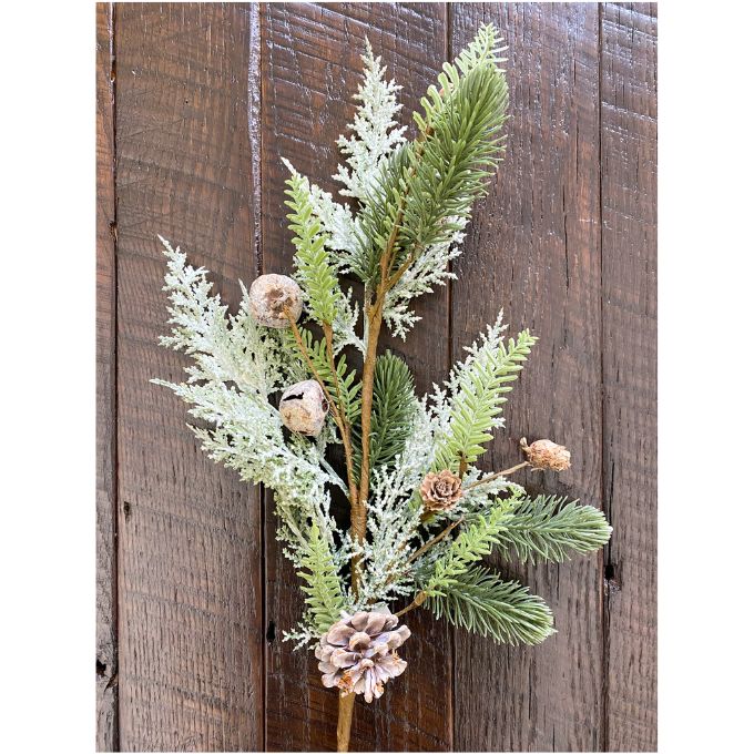 Artificial greenery with pinecones against a wooden background.  Frosted Cedar & Pine Spray - 30" tall available at Quilted Cabin Home Decor.
