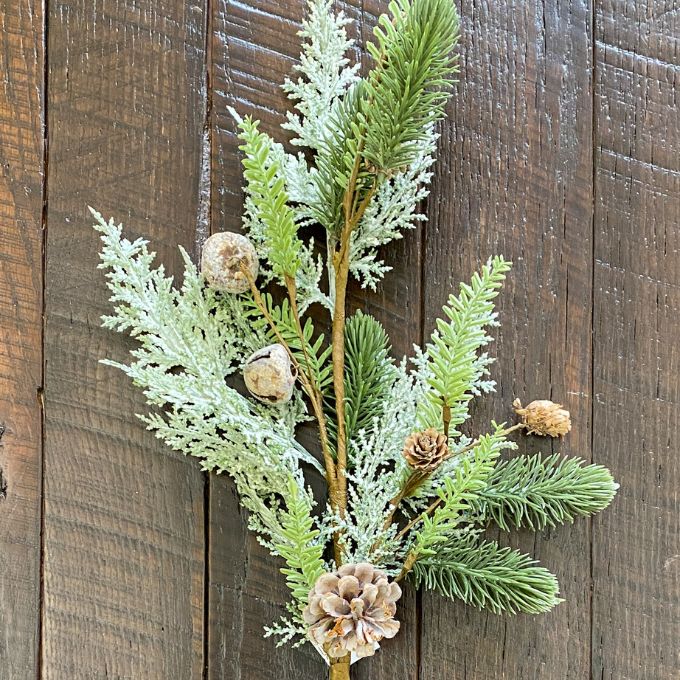 Artificial greenery with pinecones and acorns on a wooden background. Frosted Cedar & Pine Spray - 30" tall available at Quilted Cabin Home Decor.
