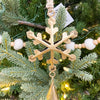 Decorative gold snowflake ornament on a Christmas tree with lights and beads. Vintage Gold Snowflake Ornaments - Set of Three available at Quilted Cabin  Home Decor.