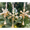Gold snowflake ornaments with bells hanging on a Christmas tree. Vintage Gold Snowflake Ornaments - Set of Three available at Quilted Cabin  Home Decor.