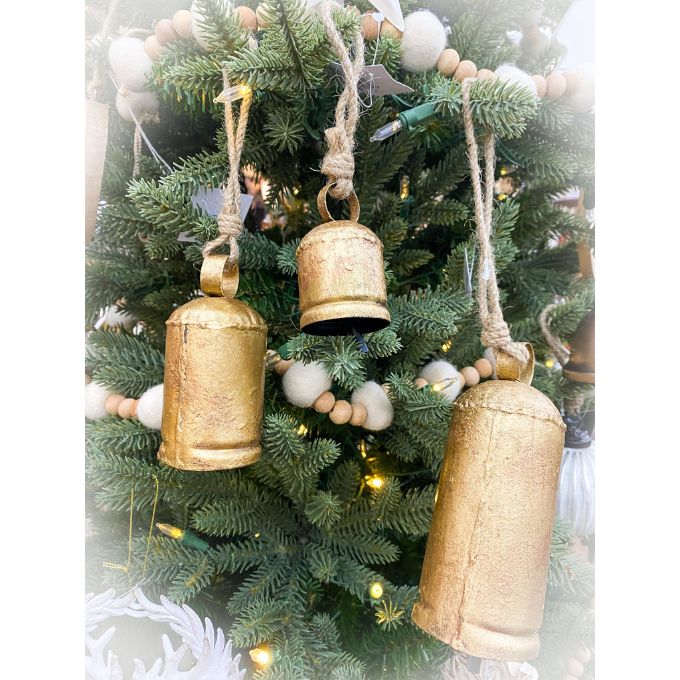 Gold bell ornaments hanging on a decorated Christmas tree. Gold Clapper Bells - Three Sizes available at Quilted Cabin Home Decor.
