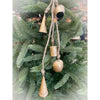 Decorative gold bell ornaments hanging on a Christmas tree. Mixed Gold Bells Hanger available at Quilted Cabin Home Decor.