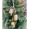 Decorative gold bells hanging on a Christmas tree. Three Gold Clapper Bell Hanger available at Quilted Cabin Home Decor.