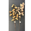 Two artificial flowering branches with peach, orange, and cream blossoms on brown stems, displayed against a dark gray background.  Available on line at quilted cabin or at Rustic Ranch furniture in Airdrie