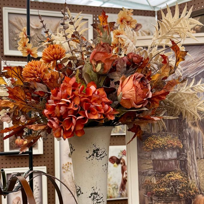 Two artificial flowering branches with peach, orange, and cream blossoms on brown stems, displayed against a dark gray background.  Available on line at quilted cabin or at Rustic Ranch furniture in Airdrie