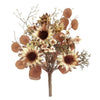 An artificial dried floral arrangement featuring large sunflowers, small cream blossoms, and round brown pods on a plain white background.  Sunflower pick available at Quilted Cabin in Airdrie