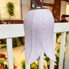 White tulip bell hanging on a white railing with a blurred indoor background. Tulip Bells - Three Colours available at Quilted Cabin Home Decor.