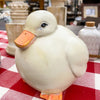 White ceramic duck figurine on a red and white checkered tablecloth.  Chubby White Resin Duck Figurine available at Quilted Cabin Home Decor.
