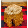 Wooden log stump on a red and blue checkered fabric.   Tree Trunk Riser is available at Quilted Cabin home decor.