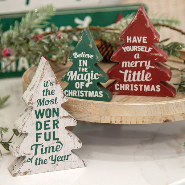 Three styles of the Wonderful time of the year christmas trees. They are wooden, distressed white, red or green with different sayings. Available at Quilted Cabin Home Decor.