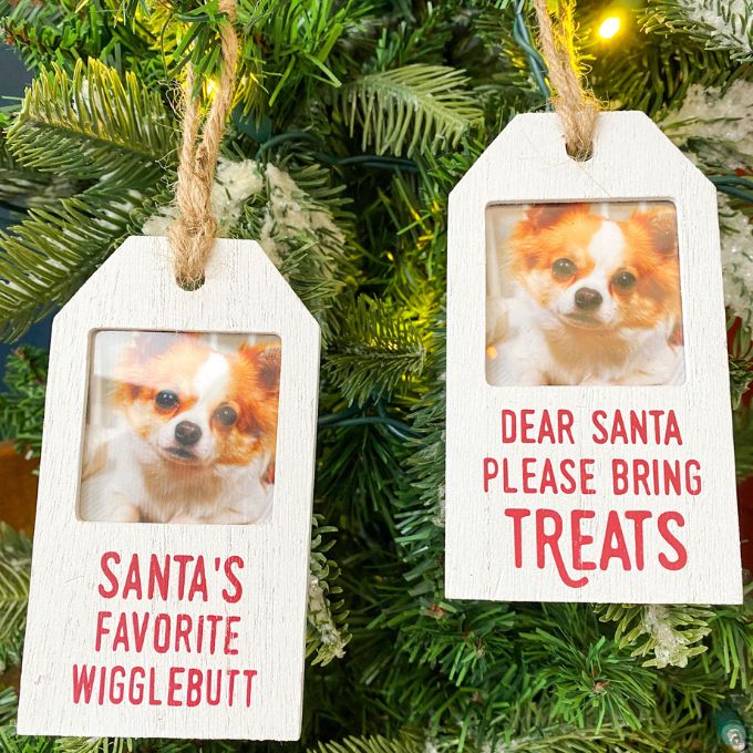 White wooden tree ornaments for dog owners with a space for a photo of your dog. The lettering is red. Available at Quilted Cabin Home Decor.