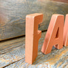 Orange wooden letters that spell FALL are available at Quilted Cabin Home Decor.