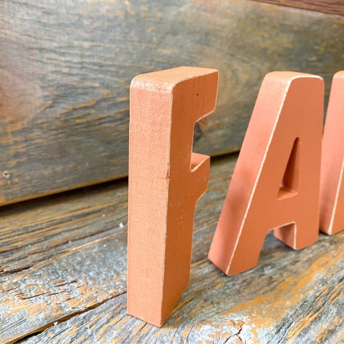 Orange wooden letters that spell FALL are available at Quilted Cabin Home Decor.