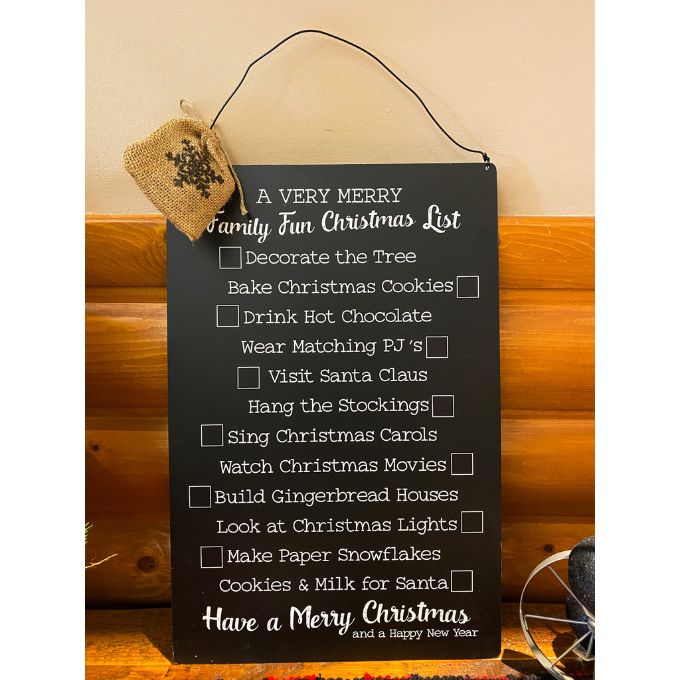 Family Fun Christmas Metal Sign available at Quilted Cabin Home Decor. The sign lists different Christmas activities and has christmas themed magnets .