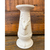 White pillar candle holder with deer design on a wooden background. Christmas Deer Pillar Candle Holder available at Quilted Cabin Home Decor.