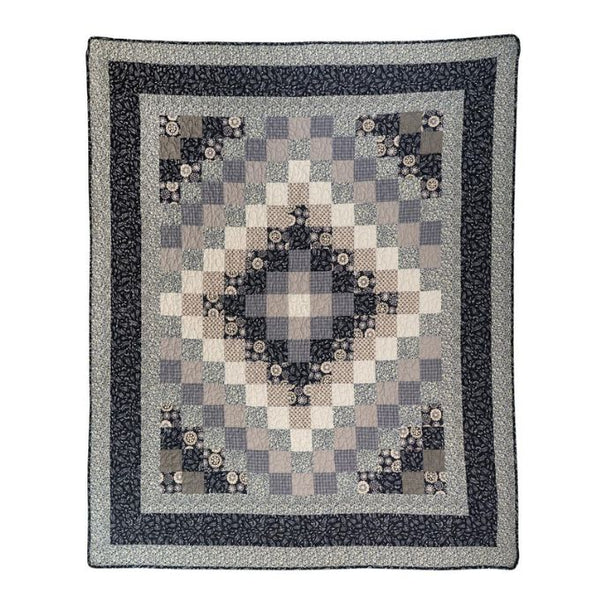 Patchwork quilt with geometric pattern on a white background. Lexington Trip Throw Quilt available at Quilted Cabin Home Decor.
