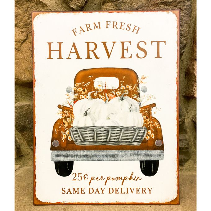 A metal fall decor sign that says Farm Fresh Harvest. An orange vintage truck is filled with pumpkins. Available at Quilted Cabin Home Decor.