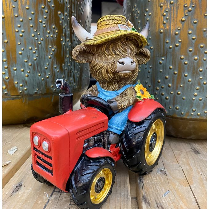 Toy figure of a highland cow in a garden hat driving a red tractor against a metallic background. Highland Cow Tractor Figurine available at Quilted Cabin Home Decor.