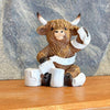 Resin highland cow figurine wrapped in toilet paper available at Quilted Cabin in Airdrie