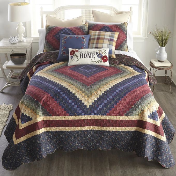 Quilted bedspread with geometric pattern on a bed in a bedroom setting. Chesapeake King Quilt Set available at Quilted Cabin Home Decor.