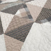 Close-up of a quilt with geometric pattern in neutral colors. Smoky Star Queen Quilt Set available at Quilted Cabin Home Decor.