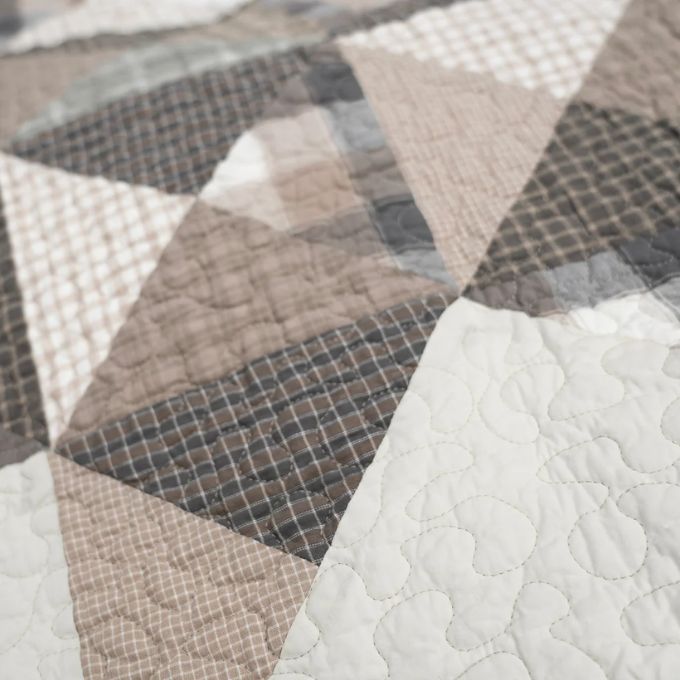 Close-up of a quilt with geometric pattern in neutral colors. Smoky Star Queen Quilt Set available at Quilted Cabin Home Decor.