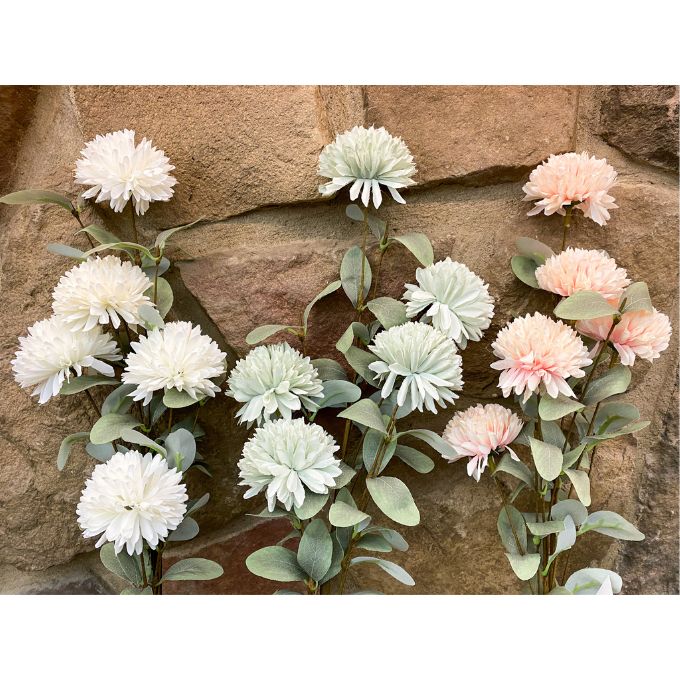 Artificial flower garland with white, blue and pink flowers against a stone wall background. Amaranth Floral Stems - Three Colours available at Quilted Cabin Home Decor.