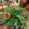 Decorative Christmas floral orb with greenery, pinecones, and red berries on a wooden surface. Berry and Cedar Dripping Floral Orbs - Two Styles available at Quilted Cabin Home Decor.