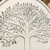 Close-up of a tree design on a white surface. Whitewashed Tree of Life Wall Art available at Quilted Cabin Home Decor.