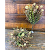 Artificial plants on a wooden surface. Cream Pincushion Floral Spray available at Quilted Cabin Home Decor.