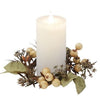 A white pillar candle with a glowing flame, surrounded by a rustic dried floral wreath with beige berries and green leaves, isolated on a white background.  Fall Floral candle ring available at Quilted Cabin in Airdrie
