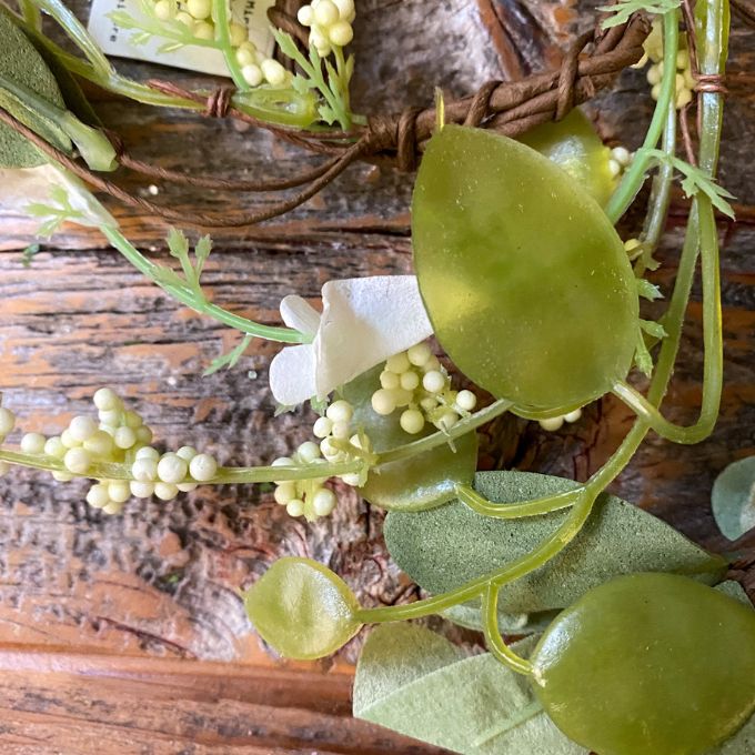 Green leaf and floral collection candle ring detail showing green leaves and small white floral clusters. available at Quilted Cabin Home Decor.