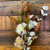 Artificial flowers on a wooden surface. Brown and Tan Flower and White Eucalyptus Spray available at Quilted Cabin Home Decor.