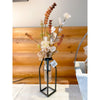 Decorative vase with flowers on a wooden surface. Brown and Tan Flower and White Eucalyptus Spray available at Quilted Cabin Home Decor.
