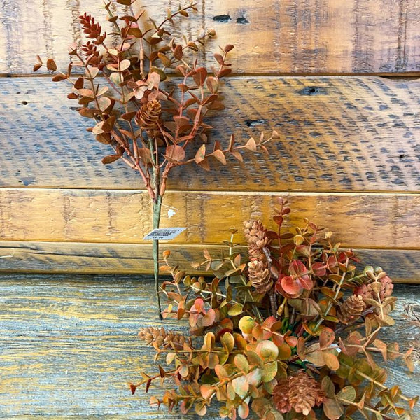 Artificial plants on a wooden surface. Fall Orange Eucalyptus and Hops Sphere or Spray available at Quilted Cabin Home Decor.