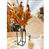 Decorative items including a vase with autumn leaves, a white plate, and a small pumpkin on a store shelf. Maple Leaf and Walking Fern Floral Spray available at Quilted Cabin Home Decor.