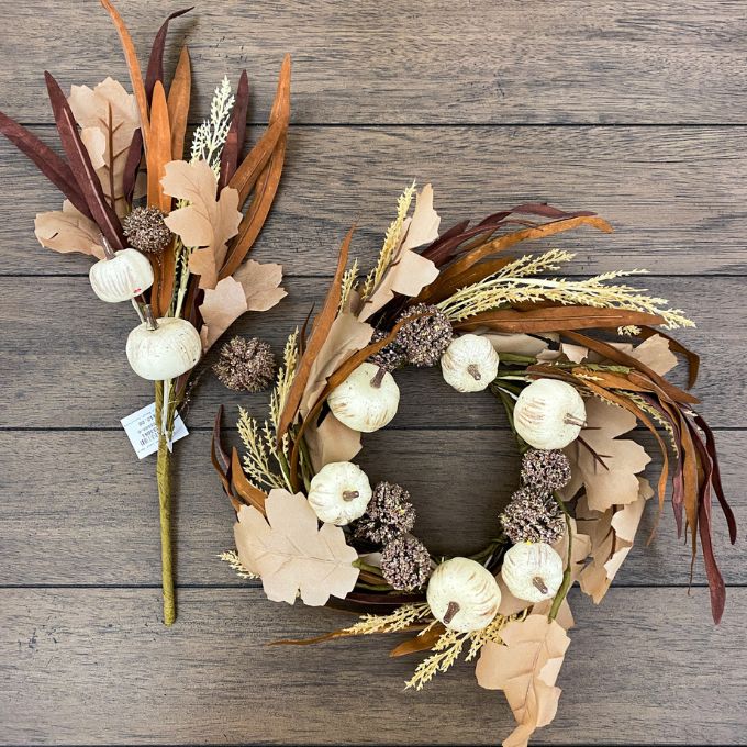Decorative wreath with pumpkins and leaves on a wooden surface. Pumpkin and Oak Leaf Candle Ring and Floral Spray available at Quilted Cabin Home Decor.