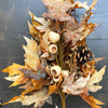 Decorative arrangement of autumn leaves, pinecones, and berries against a dark background. Earthy Maple Floral Spray available at Quilted Cabin Home Decor.