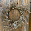 Decorative wreath with glittery branches on a wooden door. Golden Candle Ring/Small Wreath available at Quilted Cabin Home Decor.