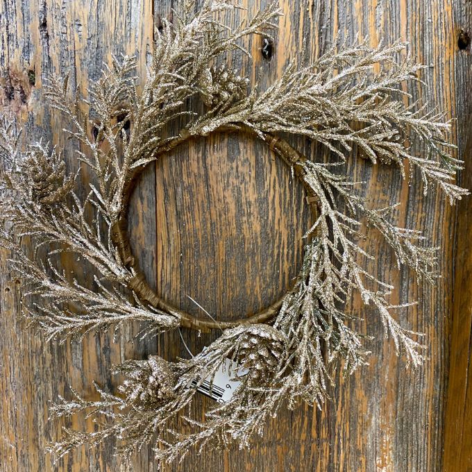 Decorative wreath with glittery branches on a wooden door. Golden Candle Ring/Small Wreath available at Quilted Cabin Home Decor.
