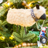 Sheep ornament on a Christmas tree with lights and decorations. Wooly Sheep Ornament available at Quilted Cabin Home Decor.