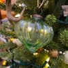 Green glass ornament hanging on a decorated Christmas tree. Vintage Green Glass Ornaments - Three Styles available at Quilted Cabin Home Decor.