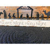 A black metal nativity scene with all characters in a row sits on a white distressed board. The words on the board say Silent Night Holy Night. It is available at Quilted Cabin Home Decor.