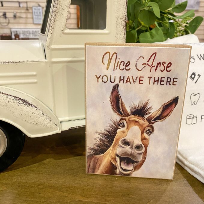 Sign with a donkey illustration and humorous text in front of a vintage truck. Complimentary Jackass Wood Block Sign available at  Quilted Cabin Home Decor.