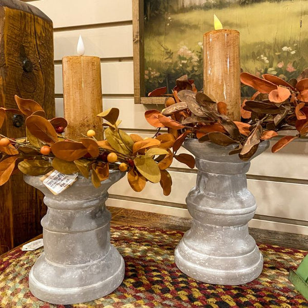 Two cinnamon LED votive candles on grey candle holders. Available at Quilted Cabin Home Decor.