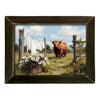Painting of a cow in a field with flowers and laundry on a line, framed in dark wood available at Rustic Ranch Furniture in Airdrie