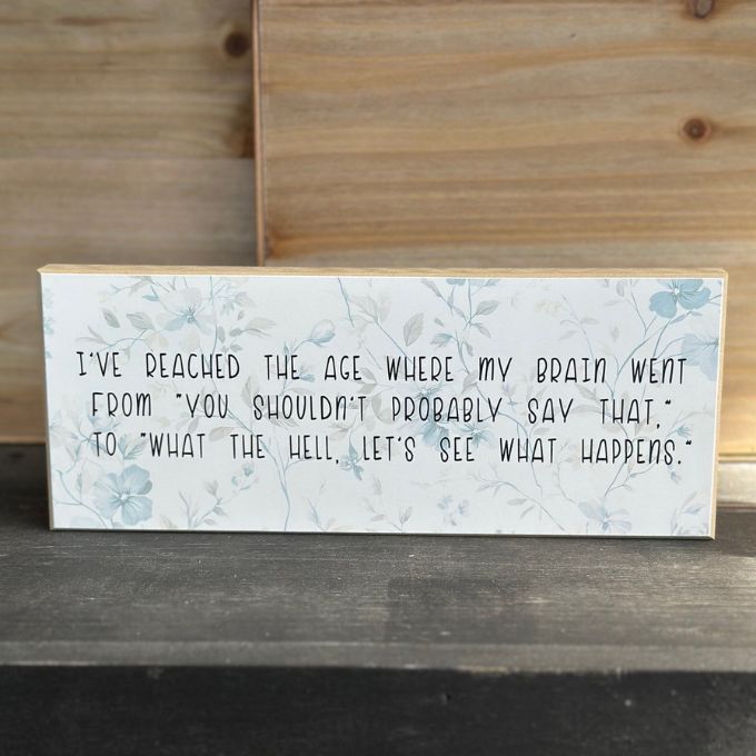 Wooden block with humorous text on a wooden surface available at Rustic Ranch Furniture in Airdrie